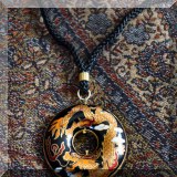 J10. Costume dragon pendant. 